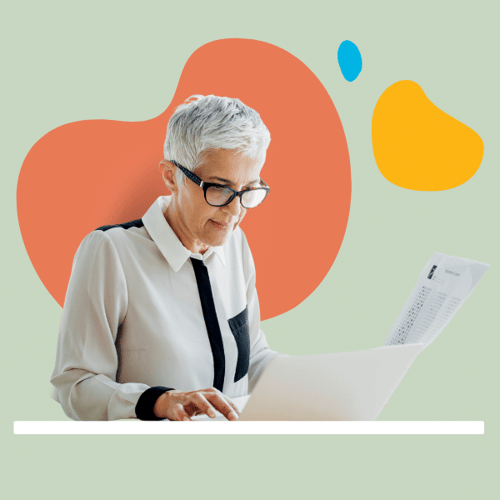 Woman working on computer with paperwork Woman working on computer with paperwork